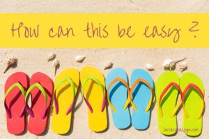 Four pairs of brightly colored flip flops on sand with words "How can this be easy?'